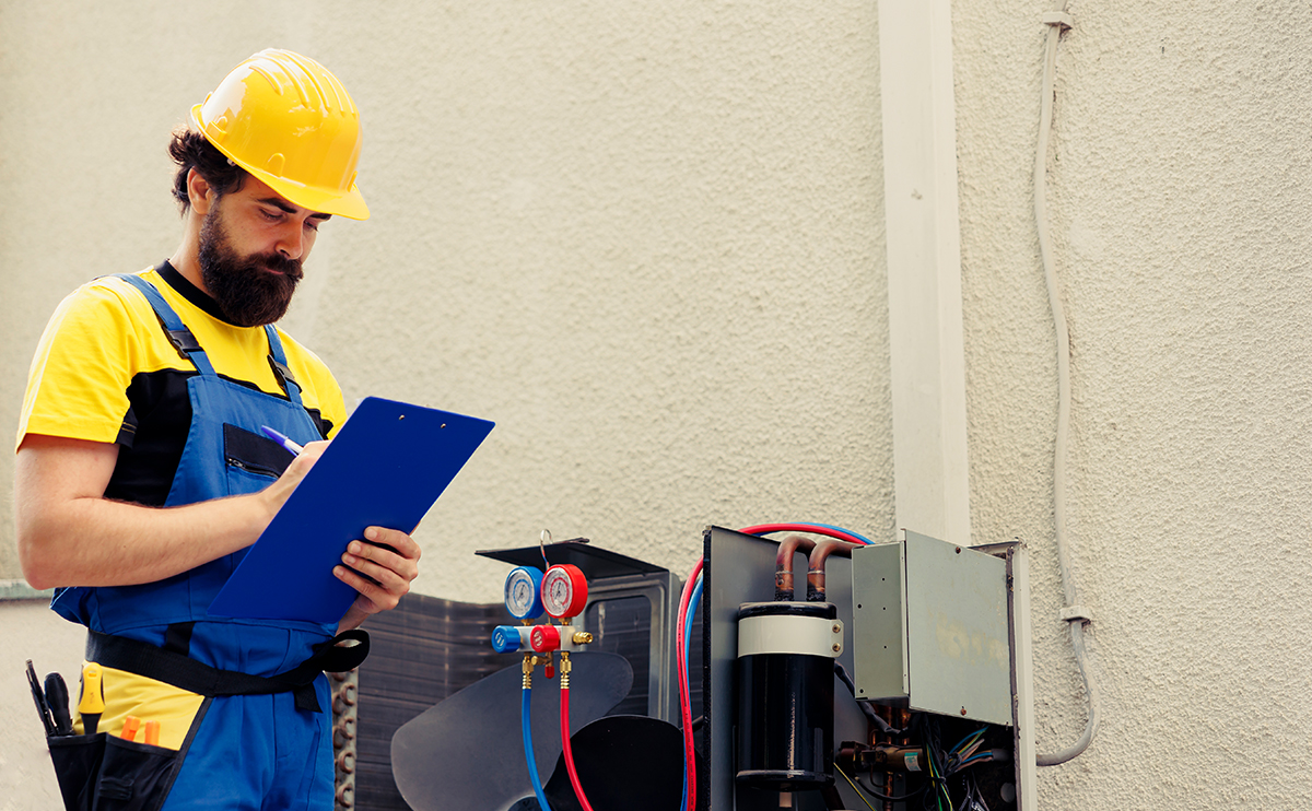 Technician checking a compressor unit.