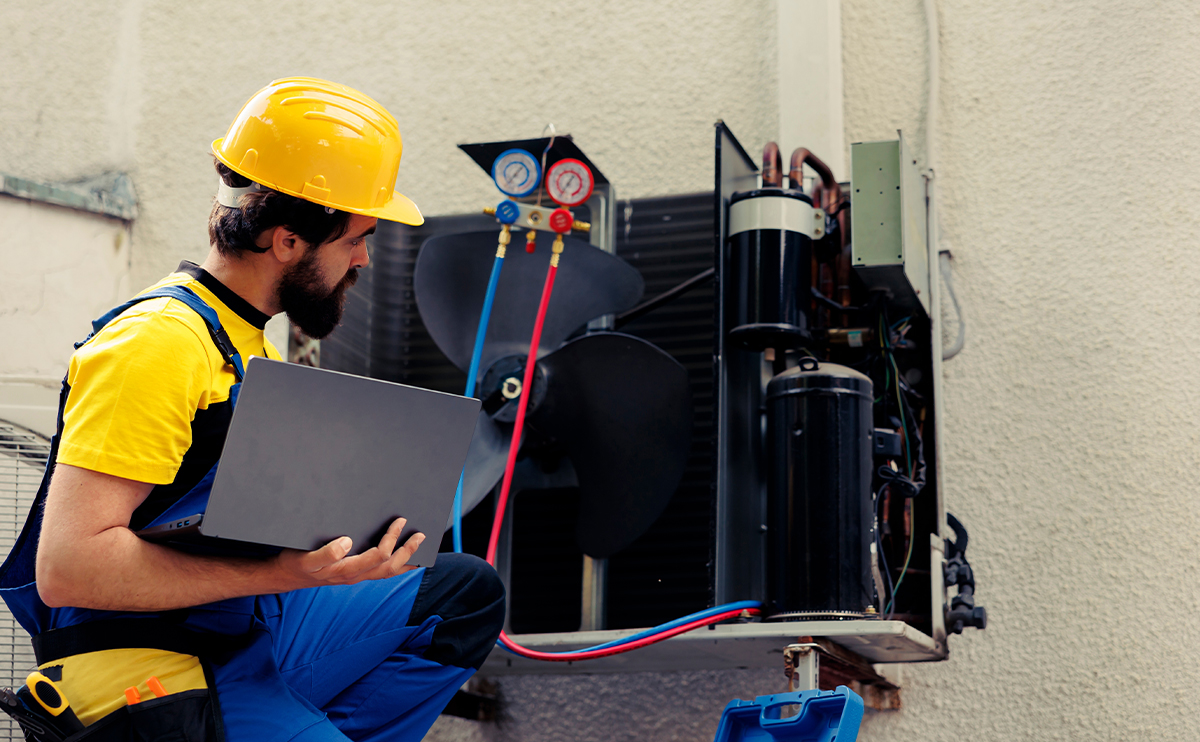 HVAC technician checking a compressor unit.