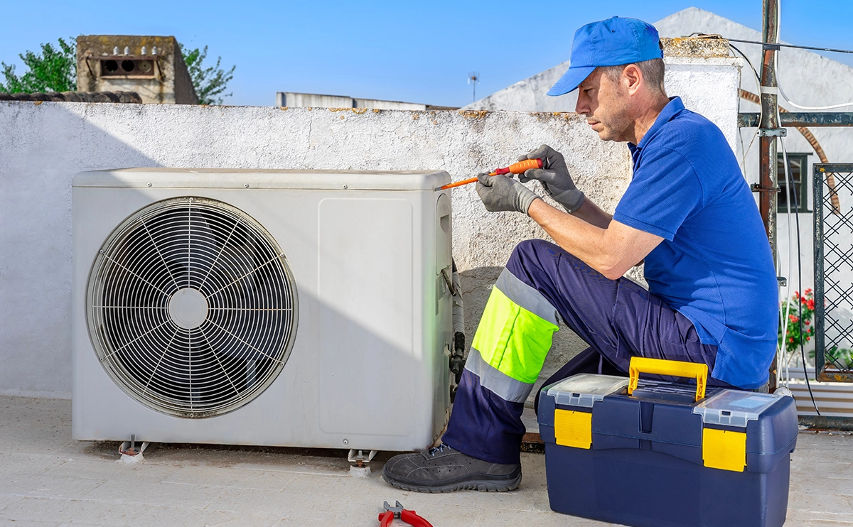 Technician repairing air conditioner